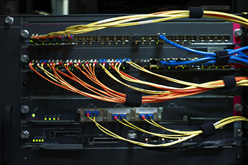 professional security camera installation on building exterior with technician working